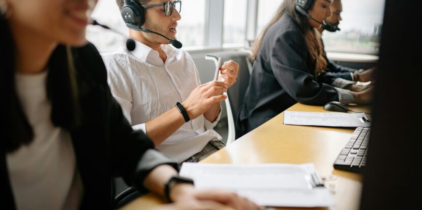 A diverse team of call center agents working together in a modern office setting.